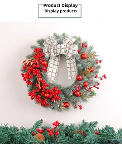 Detail of Christmas wreath with red berries, pine needles and a white checkered bow
