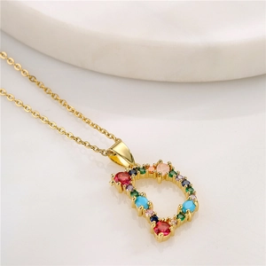 Detailed macro shot of letter D pendant necklace with colorful cubic zirconia stones