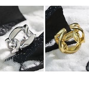Detailed macro view showing the S925 hallmark on minimalist chain link rings in gold and silver