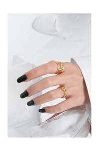 Detail of gold rings with micro-set zircons and irregular texture on model hand