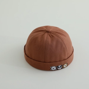 Close-up of brown cotton Miki Hat featuring cute animal embroidery of dog, panda, and bear
