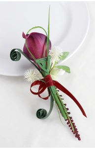 Detail of purple calla lily boutonniere with silk ribbon and secure pin attachment
