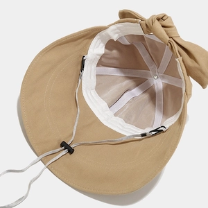 Khaki wide brim sun hat with a decorative bow and adjustable chin strap details