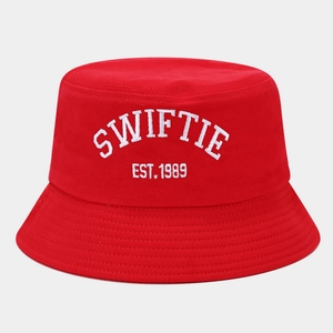 Detail of red Swiftie bucket hat featuring white 3D embroidery and EST. 1989 lettering