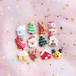 Flat lay of 12 festive Christmas resin charms including reindeer, Santa and glittery trees