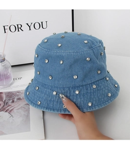 Close-up of blue denim bucket hat featuring sparkling rhinestones and premium washed texture
