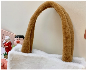 Close-up of white plush tote bag with brown handles showing soft fleece texture