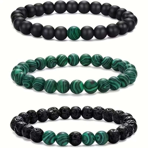 Detailed view of beaded bracelets with malachite, lava rock and matte black stones