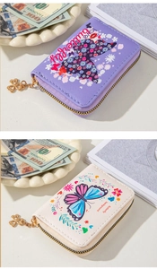 Detail of butterfly embossed PU leather card holders with gold four-leaf clover zippers