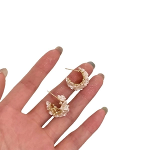 Floral C-shaped stud earrings with white flowers and small pearls on gold plating