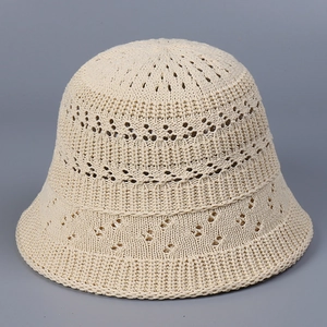 Close-up of beige crochet knit bucket hat showing hollow breathable texture and patterns