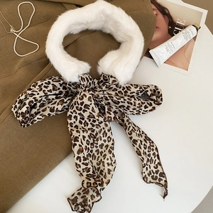Detail view of leopard print ribbon scarf with plush faux fur collar on wool coat