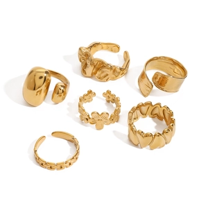 Set of six vintage gold stainless steel rings featuring heart, flower and chain motifs