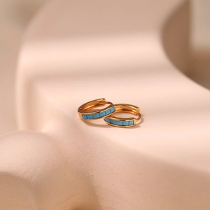 Close-up of 18K gold-plated hoop earrings inlaid with rectangular turquoise stones