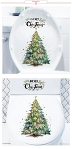 Detailed view of hand-painted watercolor Christmas tree wall stickers on a white toilet lid