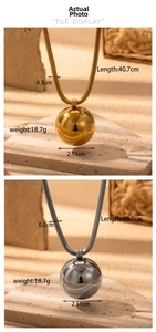 Detail view of gold and silver sphere pendants with measurements 40.7cm length and 18.7g weight