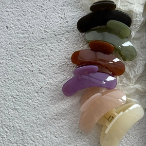 Detailed flat lay of six assorted jelly colored hair claw clips for minimalist styling
