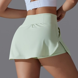Detail of high-waist mint green tennis skort with ruched back and side slit