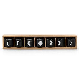 Set of 7 black ceramic candle holders with white moon phase designs in a kraft gift box