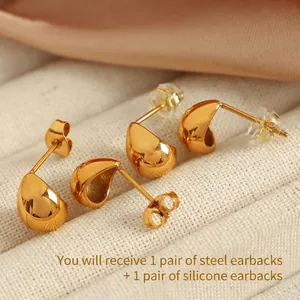Minimalist golden teardrop stud earrings with a high-polished finish and secure backings