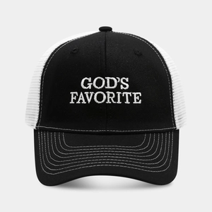 Detail showing white GOD'S FAVORITE embroidery on a black and white mesh trucker hat