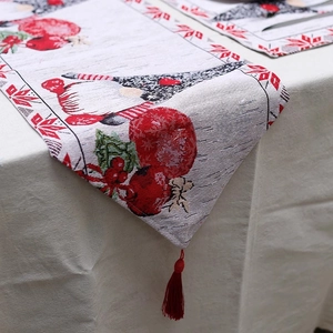 Nordic Christmas linen table runner featuring festive gnomes and red tassel decorations