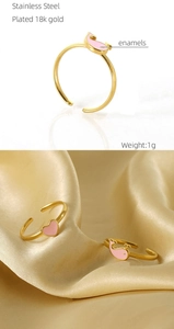 Macro shot of 18k gold plated stainless steel heart ring with pink enamel detail