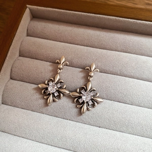 Macro shot of vintage silver iris earrings with zircon in a premium jewelry storage box