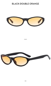 Detail view of oval cat eye sunglasses with black frames and orange gradient lenses