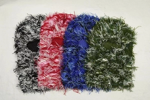 Flat lay of colorful knitted Balaclava face masks in black, red, blue, and green colors