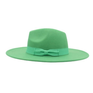 Close-up of elegant green wool fedora hat featuring a matching grosgrain bow and ribbon