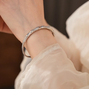 Detailed close-up of a silver bamboo-style bangle with sparkling cubic zirconia inlay