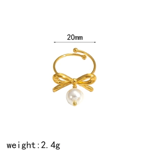 Elegant gold bow ring with hanging pearl detail and adjustable open band for women