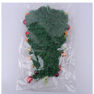 Close-up of a Christmas garland with red and gold balls in a clear protective plastic bag
