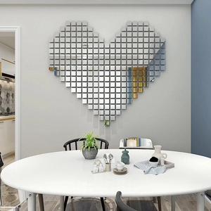 Detailed view of DIY heart-shaped wall decor made of 100 small silver acrylic mirror tiles