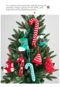 Close-up of knitted Christmas tree ornaments including stockings and candy canes
