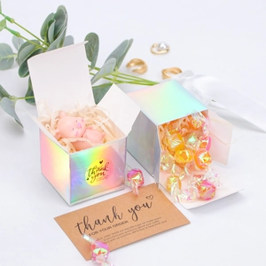 Macro view of holographic cube gift box with thank you stickers and cards for small business