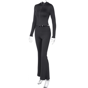 Detail of black two-piece sports set featuring a slim-fit zip hoodie and flared pants