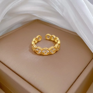 Macro shot of gold clover ring with pavé zircons on a luxury gift box packaging