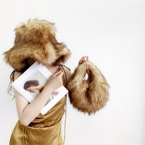 Lush faux fur hat and matching handbag set in golden brown worn in a lifestyle setting