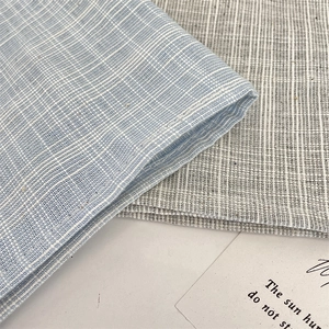 Detailed macro view of high-quality blue and grey cotton linen plaid placemat fabric texture