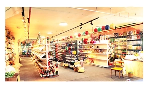 Wide angle view of a retail shop interior filled with festive Christmas ball ornaments
