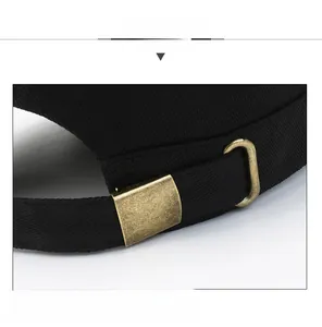 Detailed macro view of the adjustable bronze metal buckle on a black cotton flat top hat