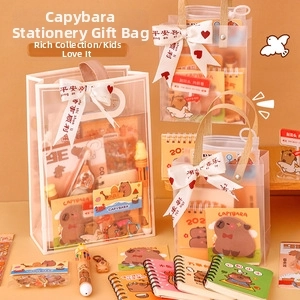 Close-up of Capybara stationery gift set with notebook, pens, and stickers in a clear bag
