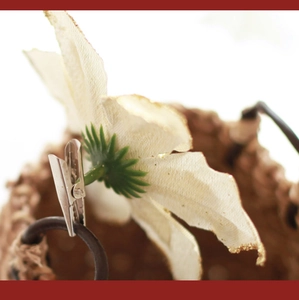 Close-up of 13cm sequined cream Christmas flower petal with gold glitter and silver clip