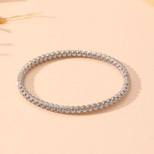 Detailed macro view of silver beaded bamboo-style bracelet with polished textured metal