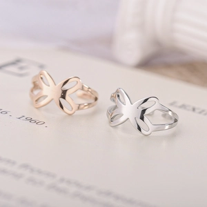 Close-up of adjustable stainless steel butterfly rings on an open magazine page