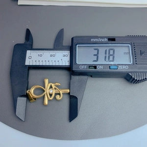 Detail view of gold ankh cross pendant with zircon, measuring 31.8mm with a digital caliper