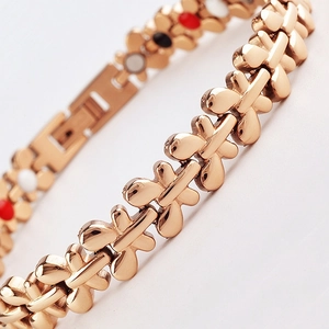 Macro shot of rose gold butterfly links bracelet with colorful round magnetic stones