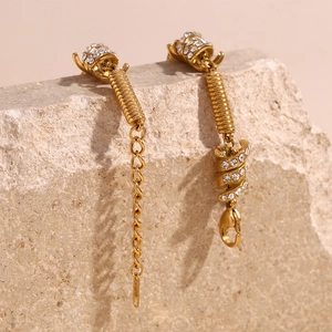 Detailed view of 18K gold plated spring knot bracelet with micro-pave crystals on stone